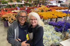 Glenn and Jennifer Morgan in the flower cage. This is where the flowers are prepped to be placed on the float. --- Photo by Erik C. Andersen