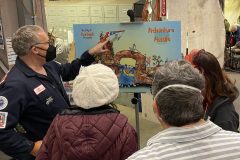 Erik shows 700 members where the hang glider will be placed, after it is decorated. Photo by Glenn Morgan